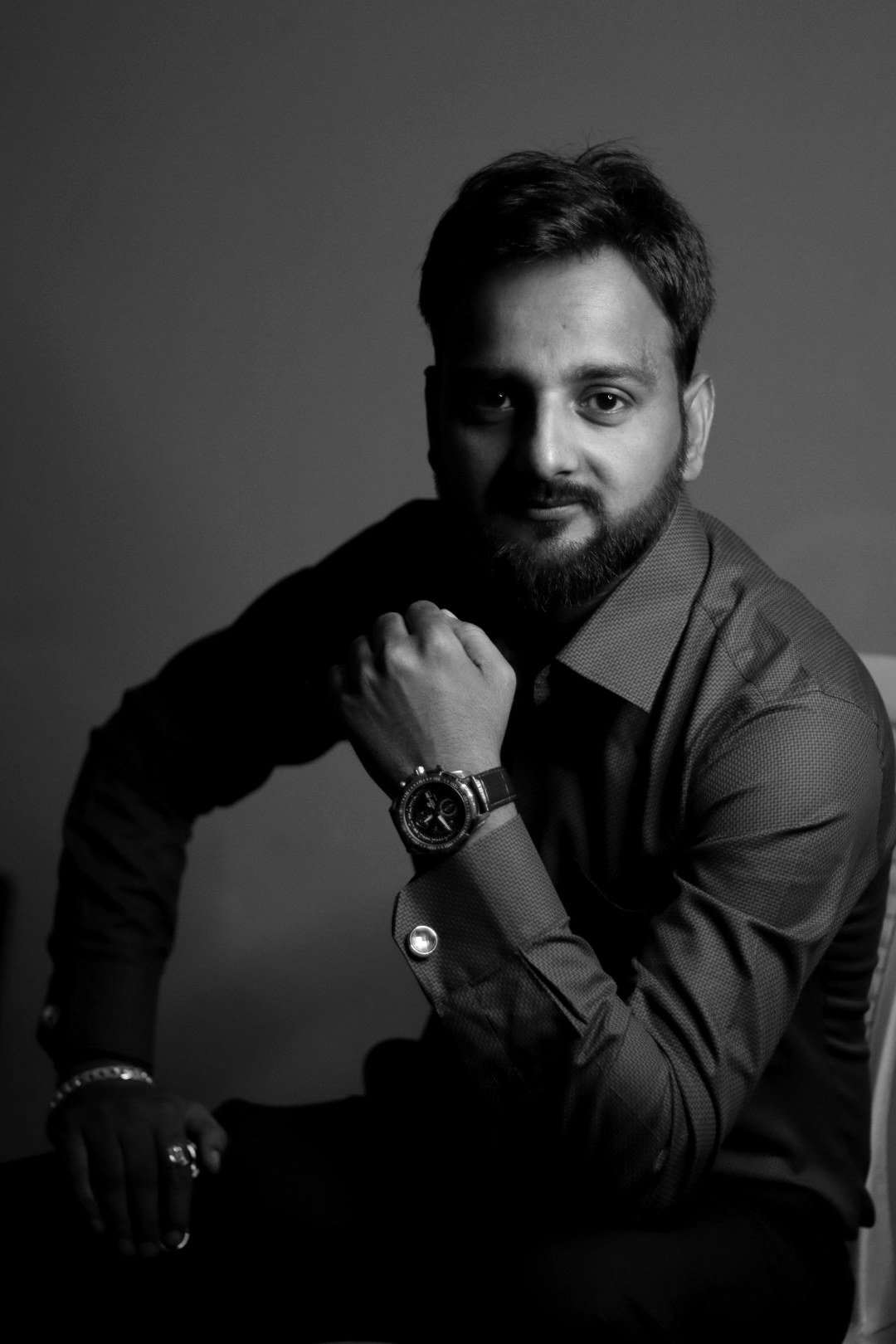 Coach Rahul Awasthi, Funnel Architect, low-key studio portrait, seated